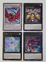 Four Yu-Gi-Oh foil cards laid out showing card details and condition: Black Rose Dragon, Number 28: Titanic Moth, Number 21: Frozen Lady Justice, and Rairaptor - Final Fortress Falcon.