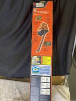 Full side view of the hedge trimmer box with product and feature information visible