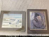 Two framed art prints side by side; one landscape icy scene, one Picasso-style nude woman print.