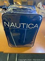Photo of Nautica twin comforter in original clear zipper bag showing brand name and zipper handle