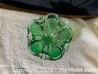 Top-down view of green glass bowl showing petal shape and texture.