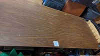 Top surface of table showing woodgrain laminate with scuffs and scratches, measuring 30" x 6'
