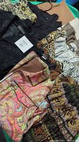 Overview of assorted ladies clothing including skirts and tops with various prints and colors.