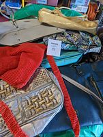 Overview of all handbags in the lot showing a variety of colors and styles including metallic gold, beige, blue pattern, and dark blue