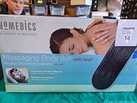 Box of Homedics Massaging Body Roll showing front with brand name and product usage image.