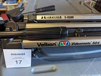 Close-up photo of Hakuba S-4500 and Velbon Videomate 504 tripods showing brand logos and part of the leg structure.
