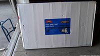 White cardboard box with blue label showing Great Choice fold and carry dog crate for XL dogs, with visible box damage.