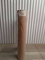 Full view of the kraft paper roll standing upright showing its height and packaging.