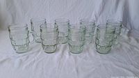 Photo showing 8 vintage Barel glass mugs arranged in two rows, highlighting their size and pattern.