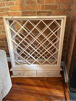 Full view of wooden wine rack with diamond grid bottle storage
