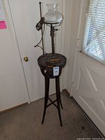 Full view of tall wood end table with attached vintage lamp, showing overall structure and condition