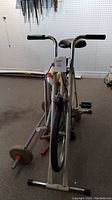 Front view of Superstar stationary exercise bike with metal frame, front wheel, and handlebars with foam grips.