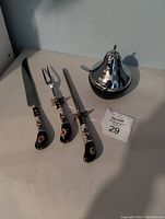 Photo showing the knife, fork, sharpener with floral enamel handles and the cobalt blue pear-shaped sugar jar with silver lid.