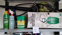 Overview photo of the lot showing various lawn and garden care products including sprayer and boxed items