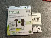 Closed original box of the Revitive Essential Circulation Booster, showing branding, features, and shipping labels.