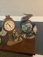 Both resin hobo clock and battery lantern displayed together on a table showing size and details.