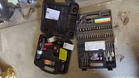 Jobmate cordless drill, battery, charger organized in case with bits