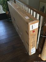 Full view of unopened box with printed label describing Orlando queen bed set, light grey fabric, by dg casa