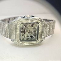 Close-up photo of the full bustdown men's watch with a square face and metal band encrusted with numerous small stones.