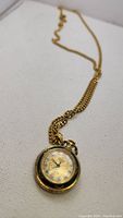 Full view of Stowa pendant watch on gold-tone chain showing overall design.