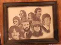 Front view of the wooden framed illustration showing nine candid portraits of The Beatles members in black and white.