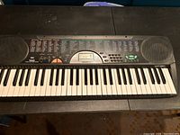Full view of Radio Shack MD-981 electronic keyboard showing keys, control panel with buttons, speaker grilles, and digital display screen.