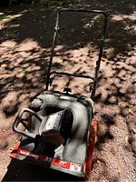 Top-down view of gas-powered snowblower showing control handle, engine housing, and front intake area with decal indicating 3.5 HP and 21 inch clearing width.