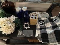 Overall layout of lot items including salt and pepper set, valance, flowers, wooden block, and other assorted items.