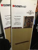 Two boxes of ClosetMaid Impressions Top Shelf Kits stacked showing brand, product line, and finish color on boxes.