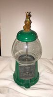 Full view of green metal and glass gumball machine with Scooby Doo figure on top.