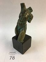 Front view of bronze torso sculpture on marble base