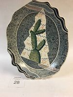 Full view of ceramic cactus platter with scalloped edges against white background.