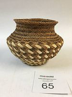 Side and front view showing the basket's shape, size, and woven pattern with a lot number card visible