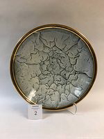 Top view of large ceramic bowl showing white crackled glaze interior and gold rim.