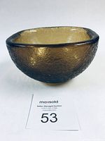 Front view of amber-hued textured glass bowl