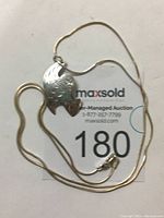 Photo showing the full necklace with hummingbird pendant on chain.