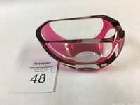 Angled front view of the pink and clear glass ashtray showing shape and color