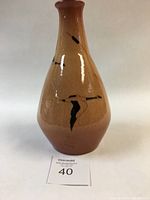 Front view of the tapered red clay ceramic vase with black geese motif and clear glaze.