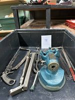 Overview of the collection including the bench vise and various saws and hand tools in a black tray
