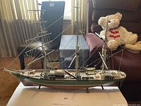 Full side view of the vintage plastic model boat showing the entire hull and rigging details.