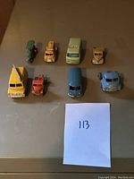 Eight vintage Lesney Matchbox toy cars and trucks displayed, showing variety in models and good condition.