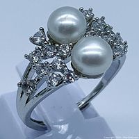 Front view of ring showing two 6mm pearls and surrounding accent stones