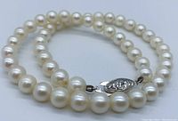 Close-up of pearl strand and silver clasp showing closure design and condition