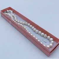 Necklace inside pink presentation case box