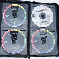 Four Beatles CDs laid out in case (Meet The Beatles!, A Hard Day's Night, Something New, Beatles '65)