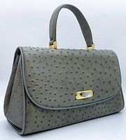 Front angle view showing flap, handle, hardware details