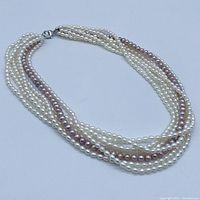 Full view of multi-strand pearl necklace showing clasp and pearl strands.
