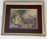 Full image of framed natural stone tiger artwork showing the entire frame and matting surrounding the stone tiger artwork.