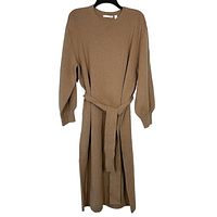 Front view of natural color wool and yak blend knit sweater dress, hanging on a black hanger showing full length and self-tie belt.