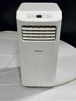 Front view of white Hisense portable air conditioner showing air vent and digital control panel.